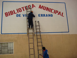 Putting the final touches on the exterior library sign.